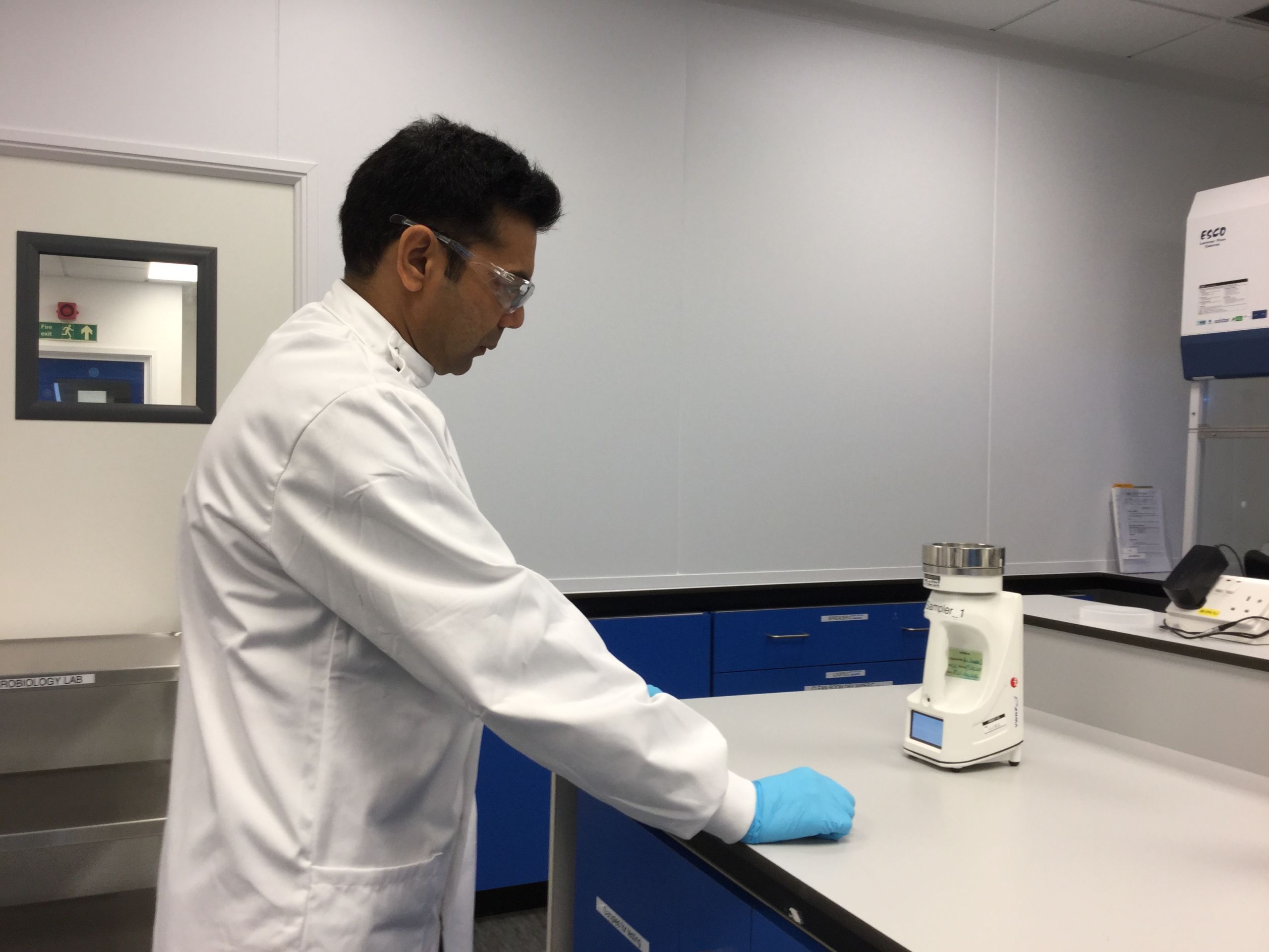 Microbiologist Jaydev Patel studying the micro-organisms at Aspire Labs